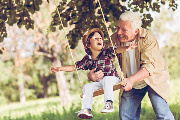 grandfather and grandson swinging together