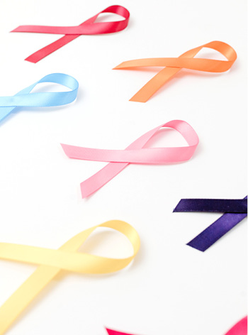 5 cancer ribbons blue orange yellow pink purple sitting on white background