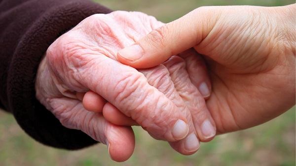 enlarged photo of young adult hand holder older adult hand