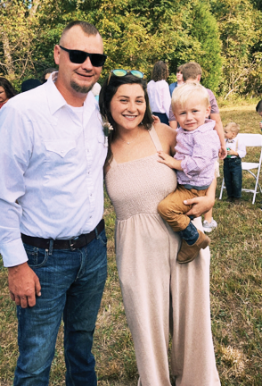 Young couple with small child smiling for photo. Megan, employee of Fordsville Nursing and Rehab pictured with husband and her little boy.